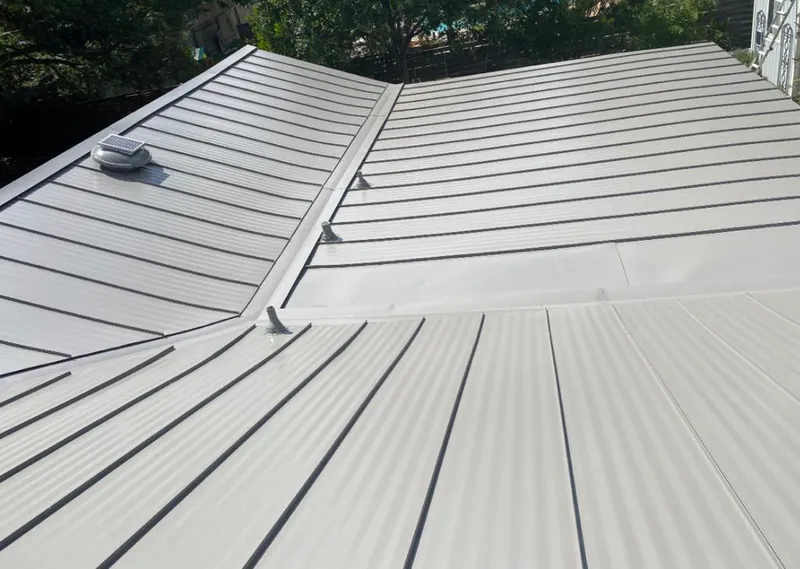 Solar attic fan installed on a metal roof for Roof Ventilation in Old Town